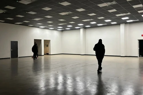 Venue transformed with dynamic pink and purple uplighting — full crowd energy